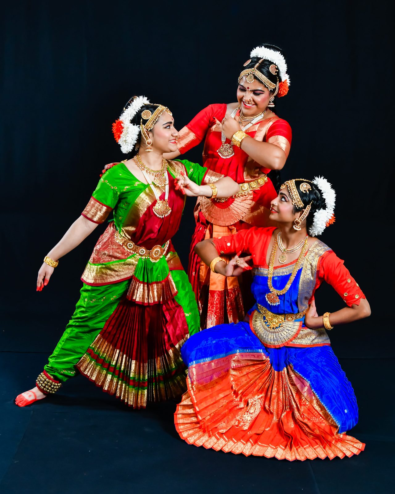 Three arangetram dancers posing together