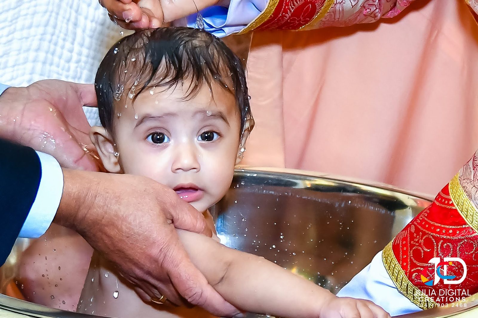 Baby looking up from the baptism basin