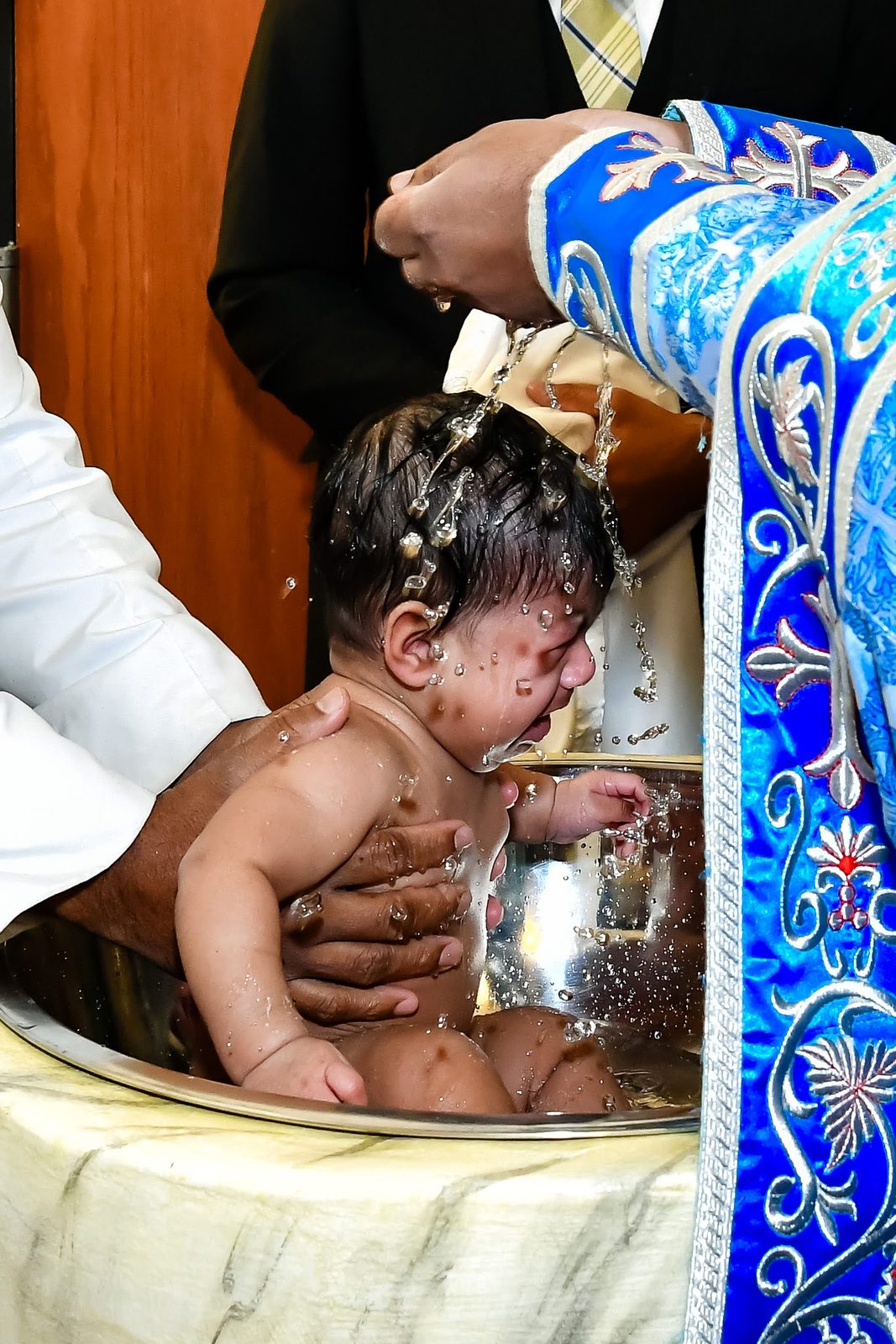 Water poured over a baby during a baptism