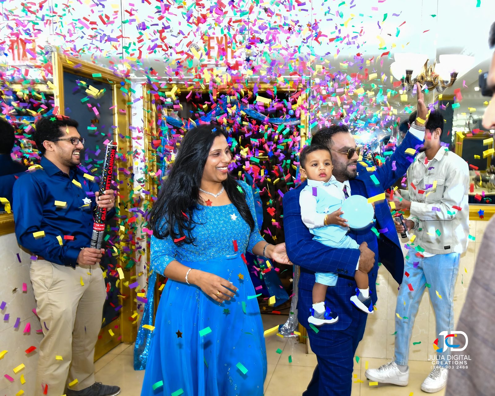 Family entrance under a burst of confetti at a birthday party