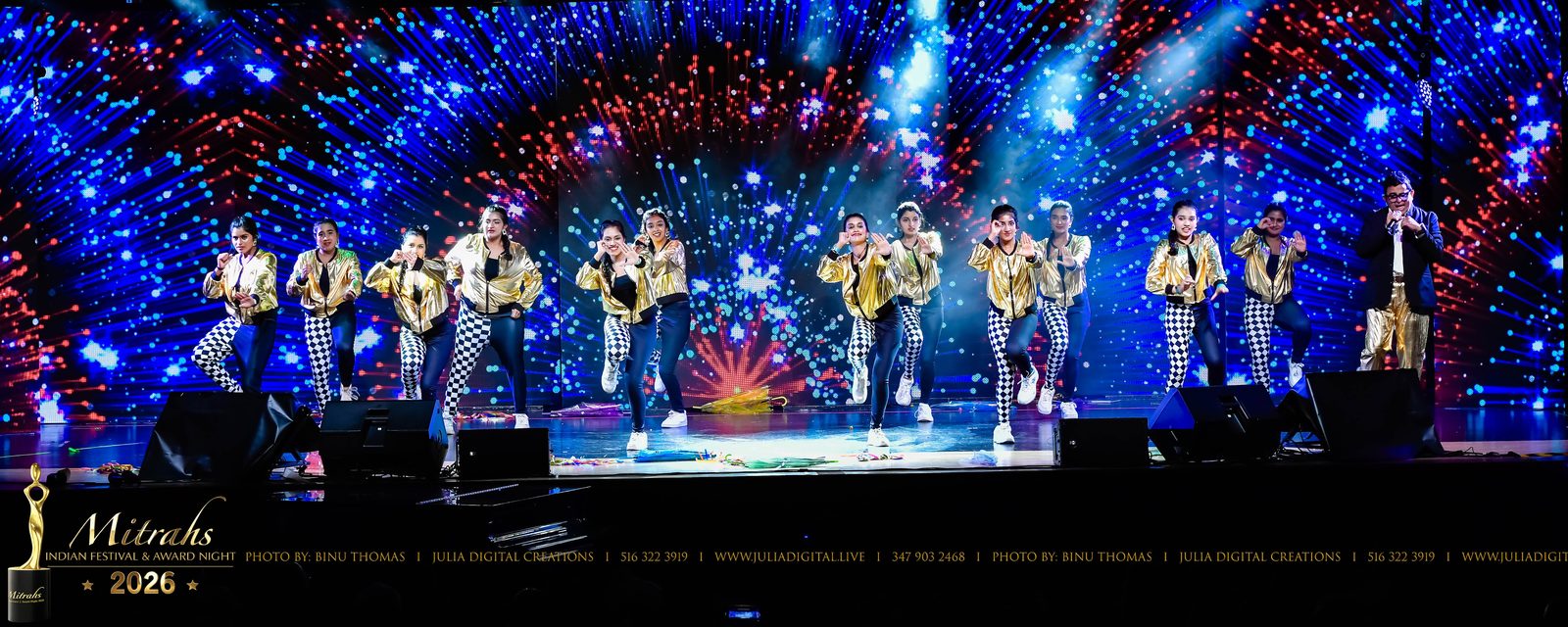 Dancers performing under blue stage lights at an award night