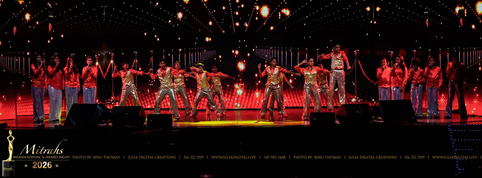 Dancers performing under red stage lights