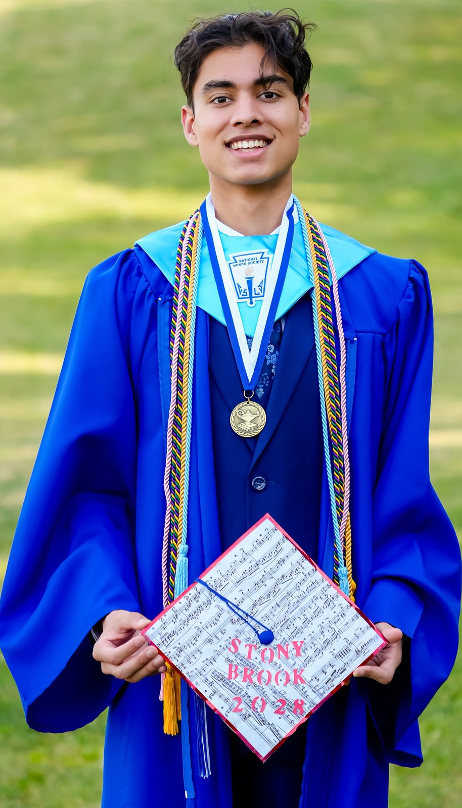 Full-length graduation portrait in blue gown