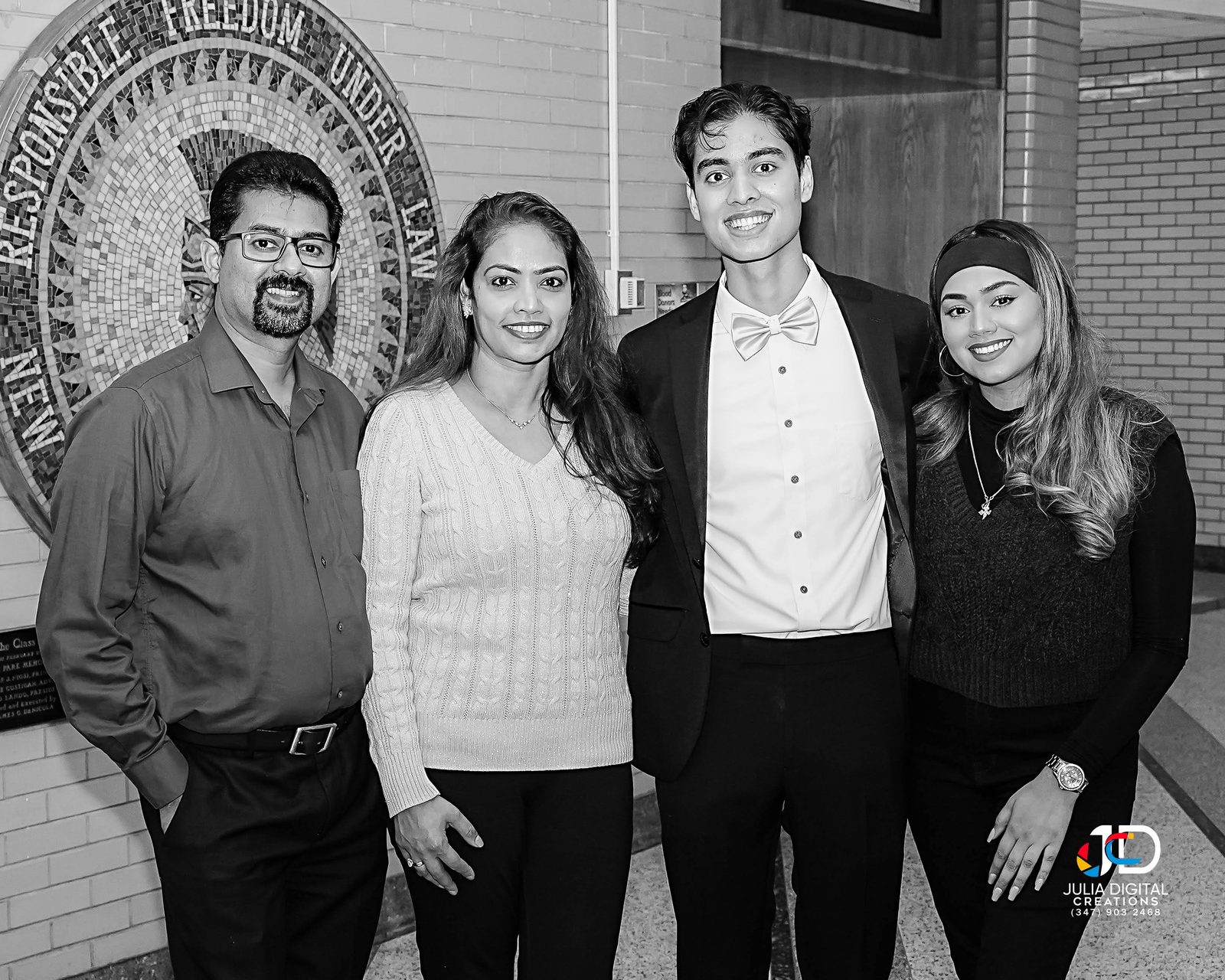 Black and white group portrait of four people